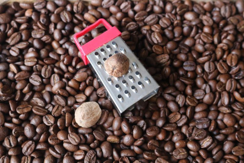 Nutmeg, a small grater and coffee beans