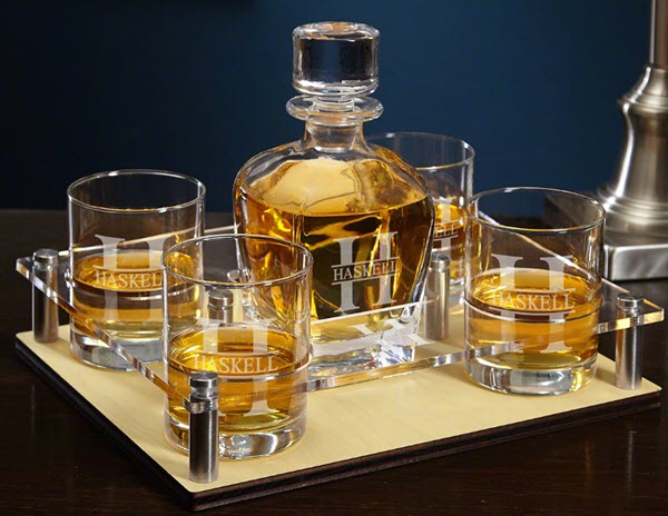 Oakmont Engraved Presentation Set | Food For Net A tray on a wooden table containing four whiskey glasses and a decanter, all engraved.