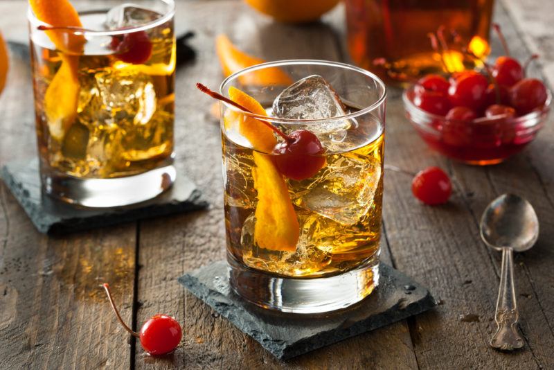 Two old fashioned cocktails with ice and twists