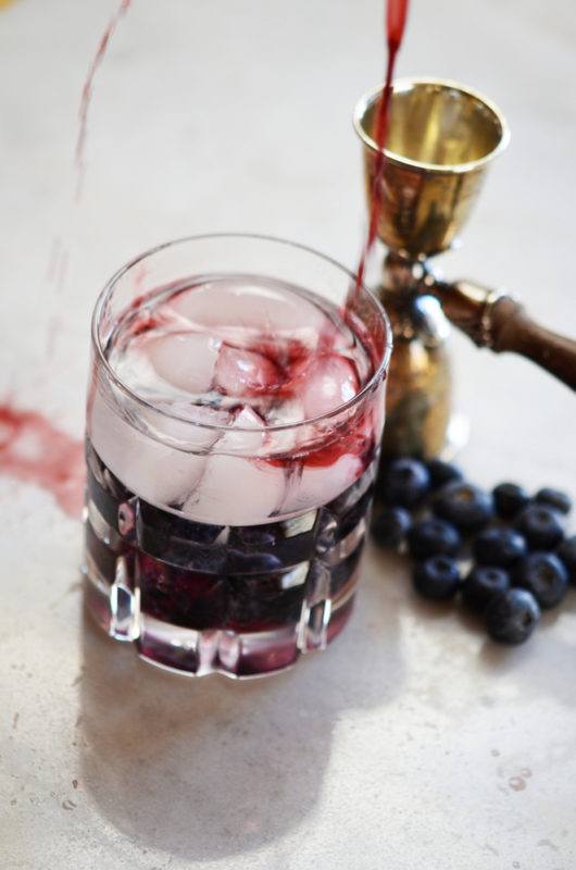 An Old Glory cocktail with berries on the bottom