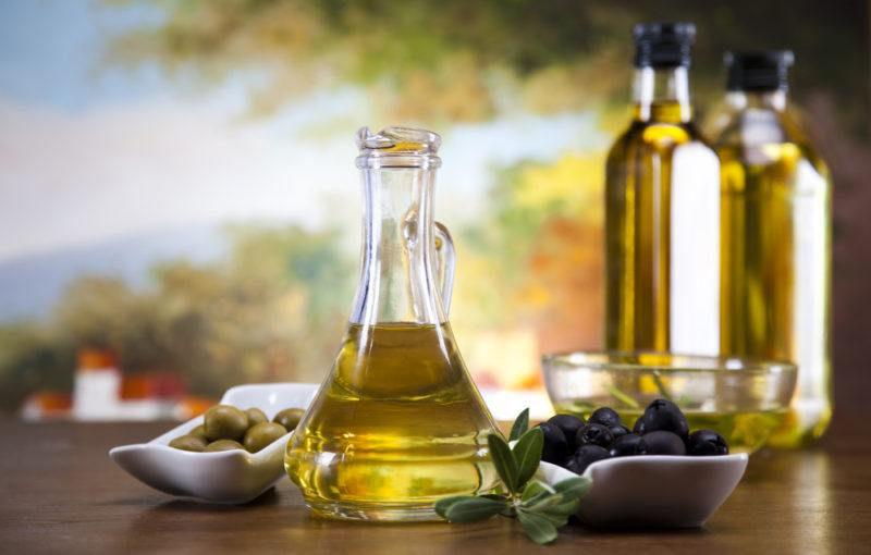 Bottles of olive oil with olives