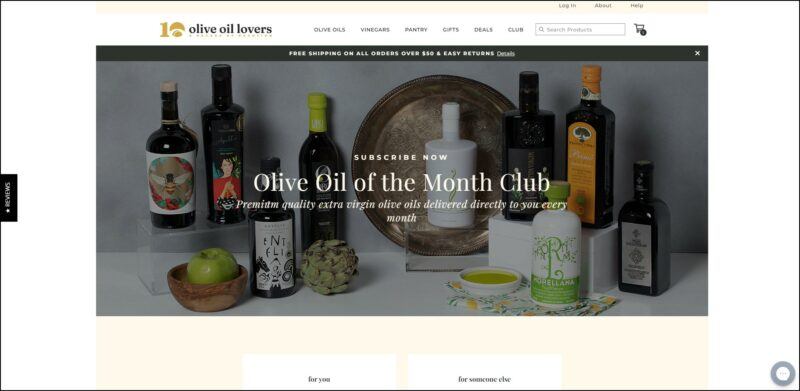 screenshot of Olive Oil Lovers Olive Oil of the Month Club's web page with beige header bearing the website's name and main menu, underneath it is a big banner with background image of the different olive oil products they carry with text overlay of the website's monthly club details