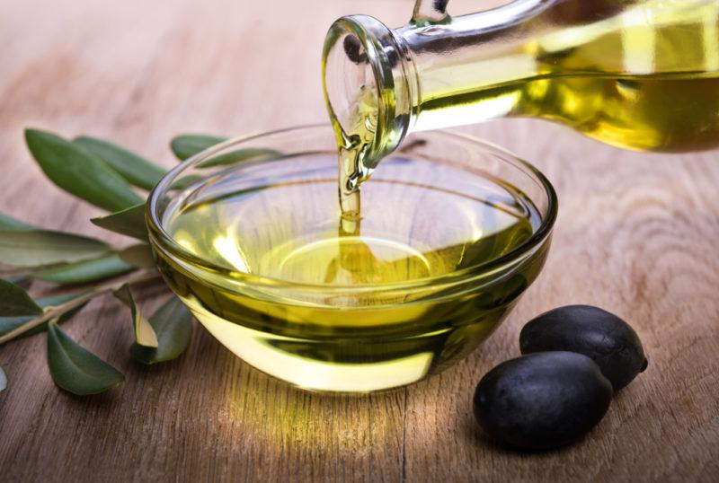 Olive oil being poured into a small dish