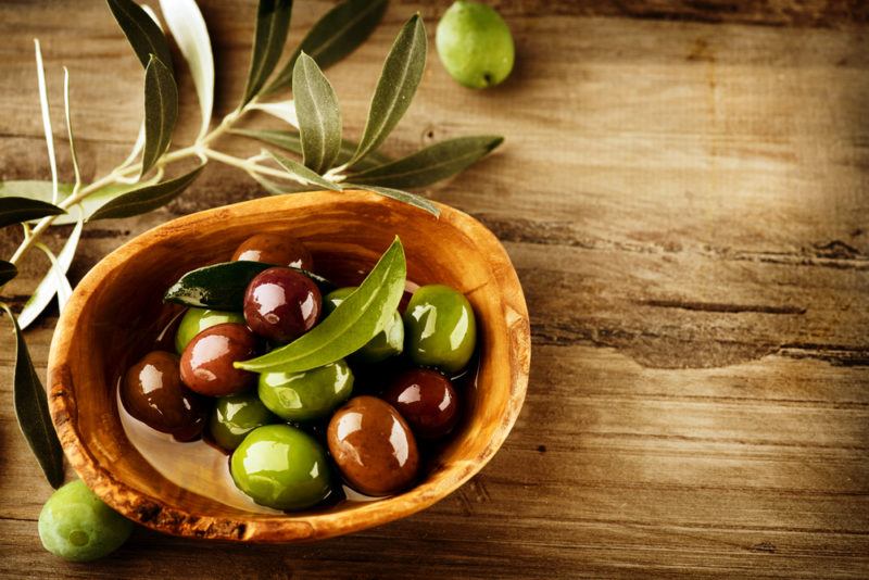 A brown bowl of fresh olives