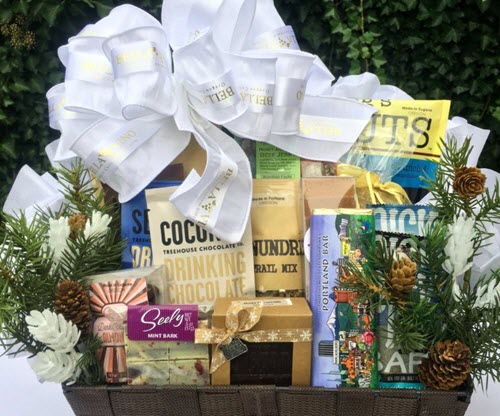 Oregon Wine & Chocolate Gift Basket Box | Food For Net A basket with various snacks and a white bow