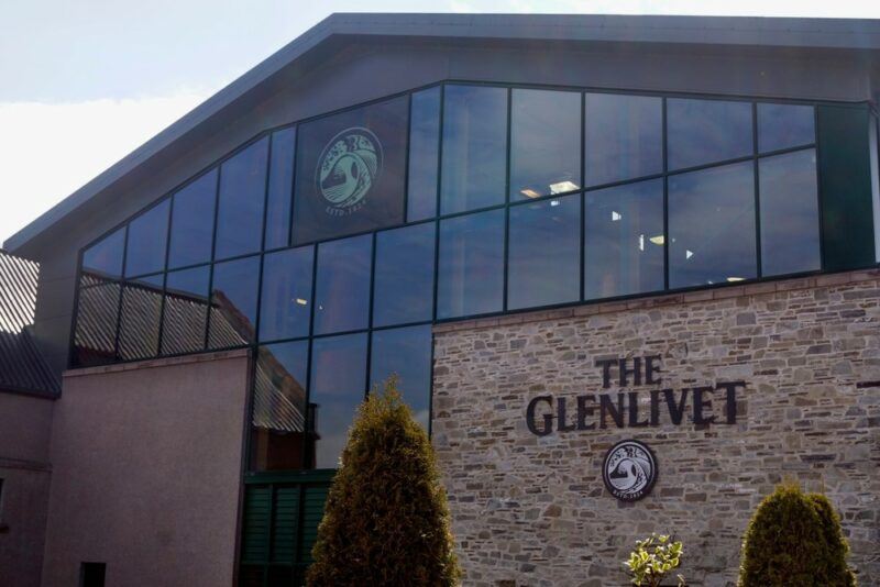 Outside the Glenlivet distillery, showing the brand's logo and plenty of glass