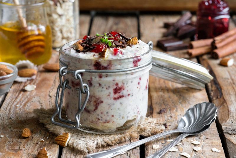 A jar containing overnight oats with berries