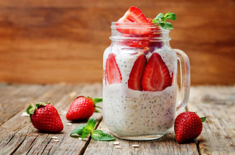 A mason jar of overnight oats with strawberries