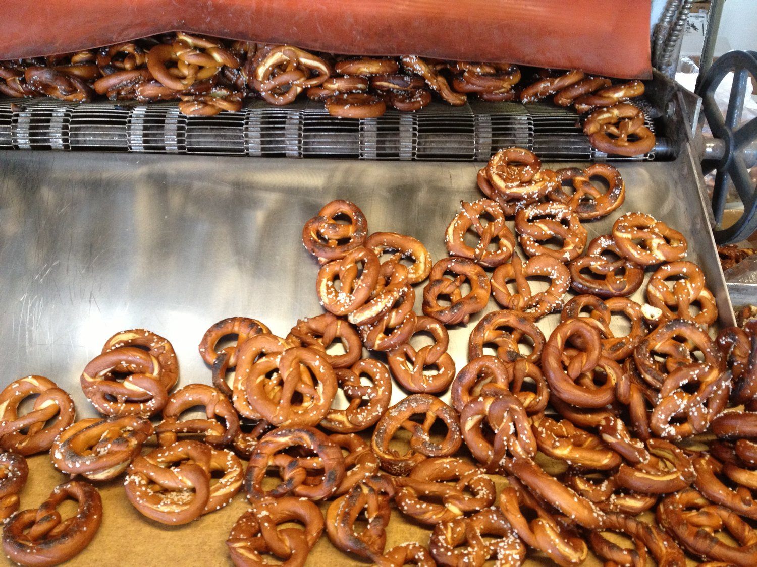 Large handmade Pretzels coming off the drying rack.