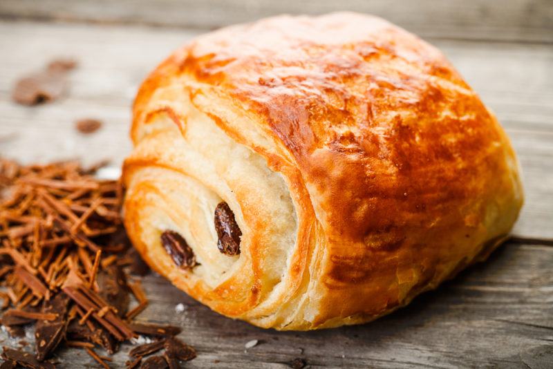 A freshly cooked pain au chocolate on a table