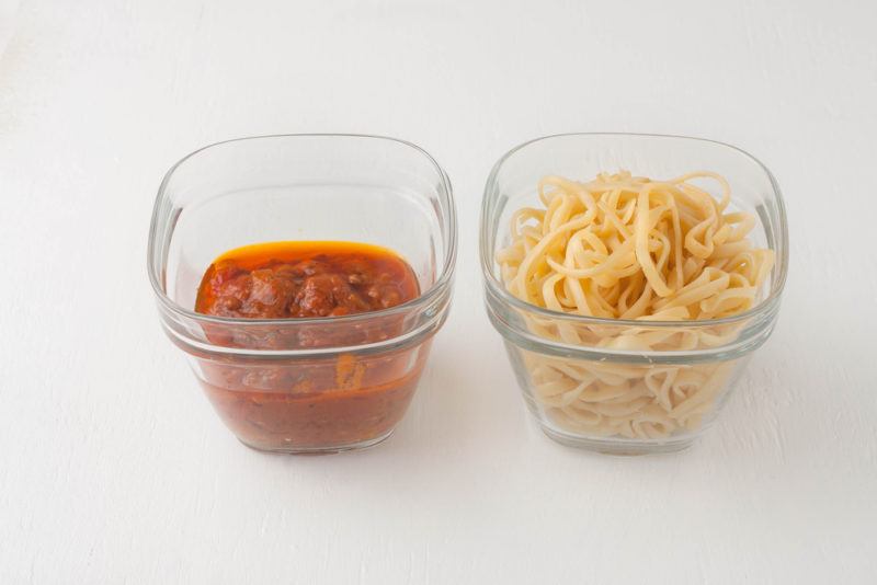 A container of pasta and another of sauce