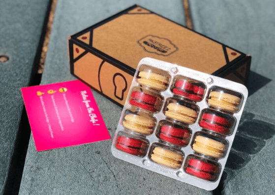 A selection of colored macarons in a box