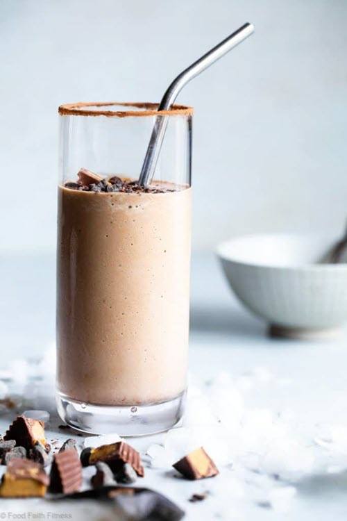 A tall glass of a low carb peanut butter smoothie with a straw