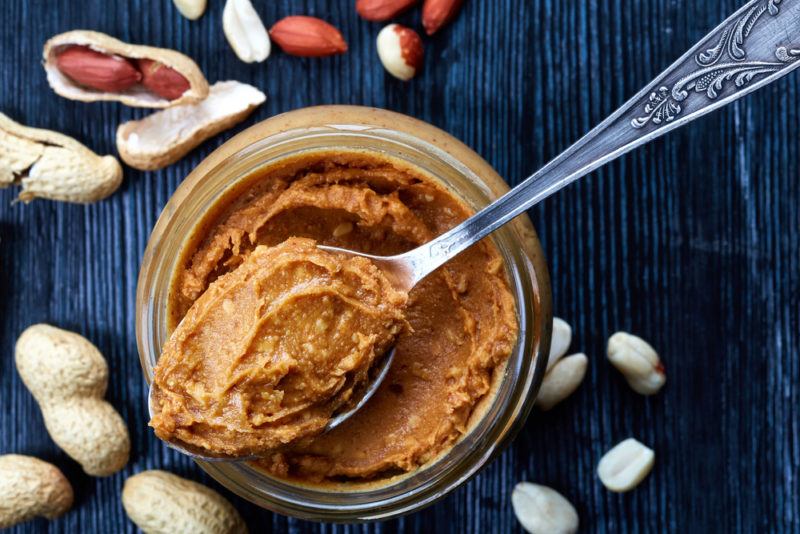 A glass jar of peanut butter with a spoon