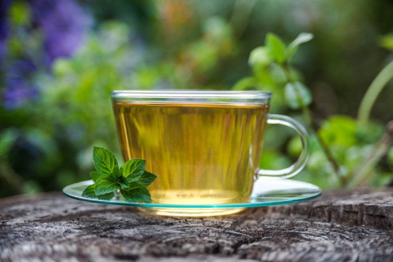 A glass mug full of peppermint tea