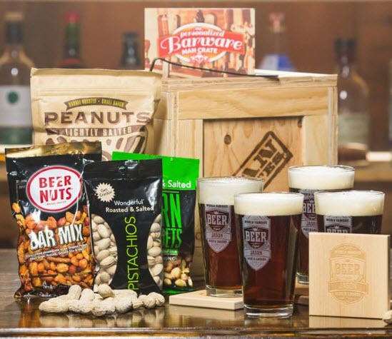 Collection of beer glasses, coasters, snacks and a crate. 