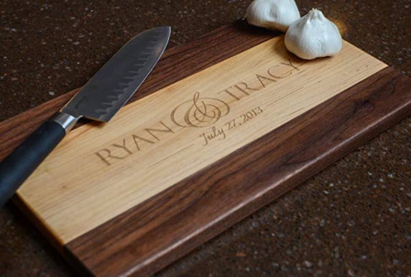 Personalized-Maple-And-Walnut-Wood-Cutting-Board | Food For Net Two-tone cutting board with a knife and cloves of garlic