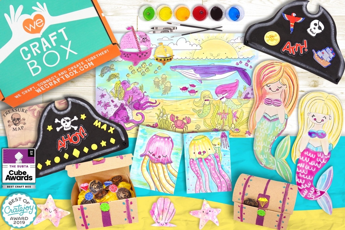 photo of We Craft Box in the upper left corner with paints, paint brushes a pictures and cut outs for crafting