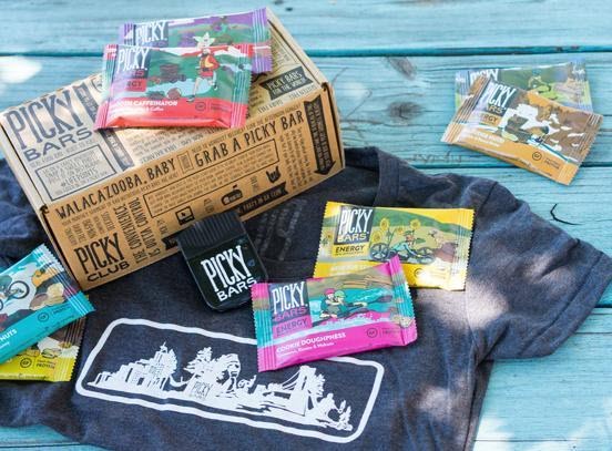 Selection of bars and a t-shirt against a wooden blue deck