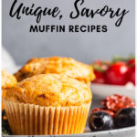 Muffins on a plate with greens, olives, and tomatoes to represent savory muffin recipes