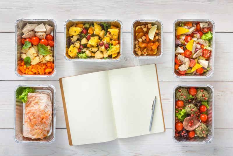 Various freezer meals surrounding a book