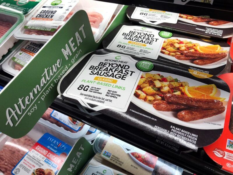 Plant-based sausages in a grocery store, with plant-based sausage from Beyond Meat showing most prominently