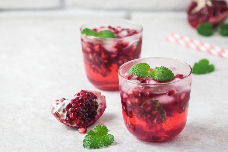 Two glasses of a pomegranate kombucha mimosa