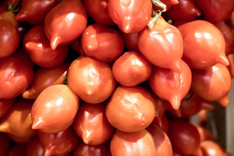 a closeup image of a bunch of Pomodorino del Piennolo del Vesuvio tomatoes