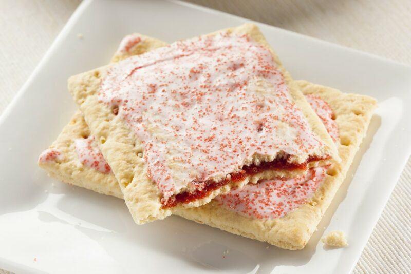 A white dish with two berry pop tarts