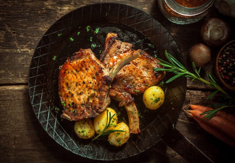 A pork chop dinner in a pan