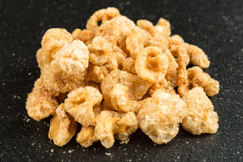 Pork rinds on a black background