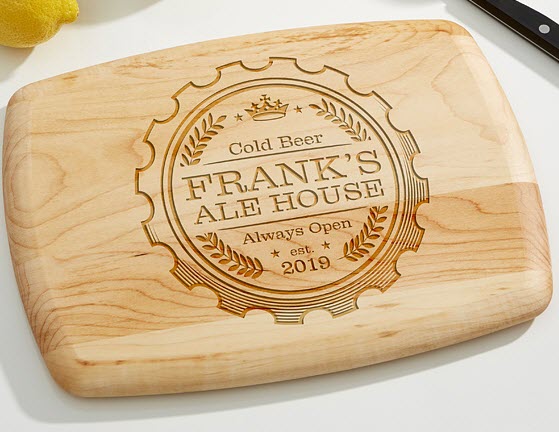 Cutting board with a bottle cap engraved and text about cold beer and Frank's Ale House