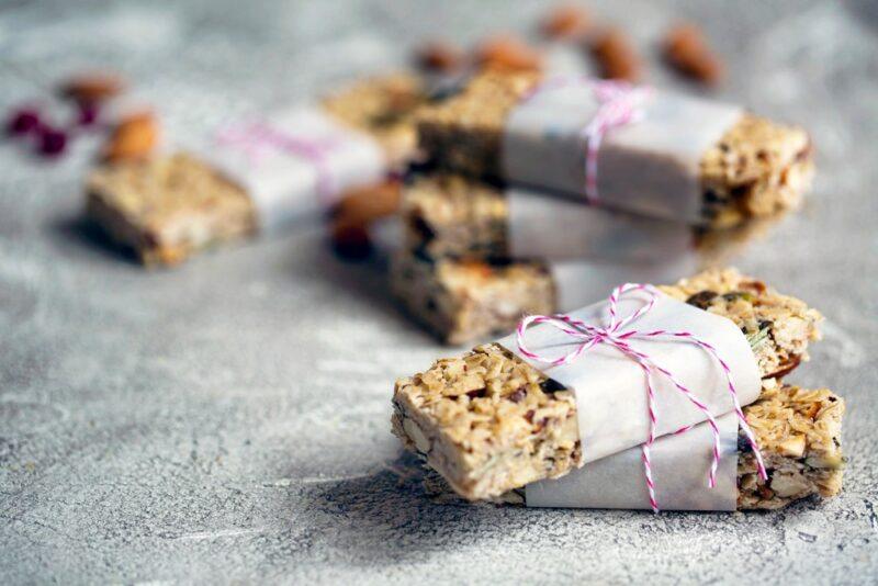 Homemade protein bars wrapped in paper and string on a table