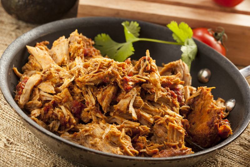 A black bowl of pulled pork