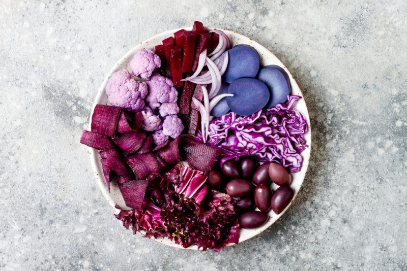 A white bowl with purple vegetables