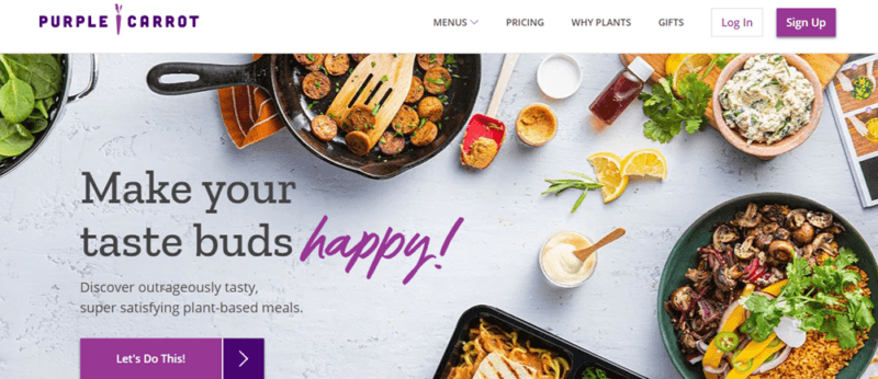 A light gray table with various fresh meals from Purple Carrot, some ingredients, and text about the company