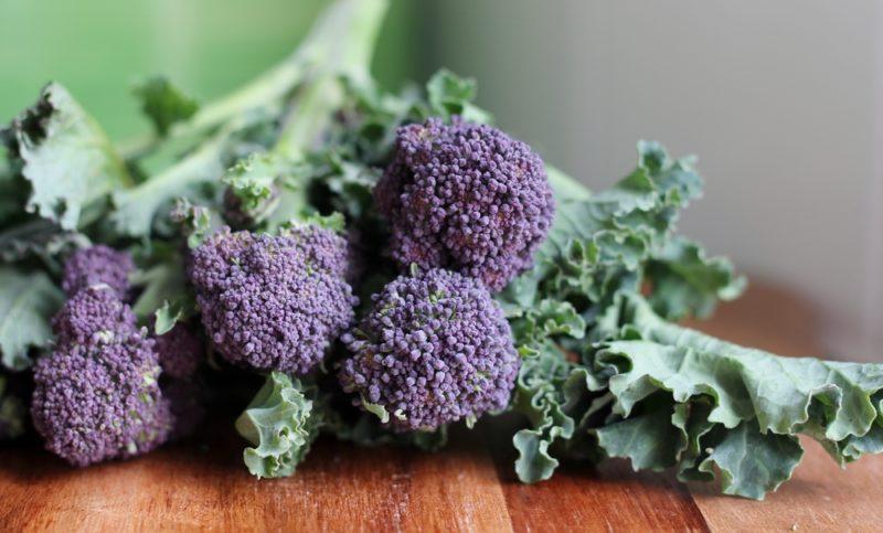 A bunch of purple broccoli on a table