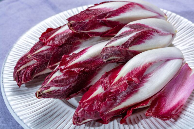 a closeup image of a white plate with a pile of Radicchio di Verona