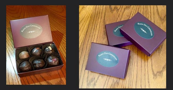 An open box of 6 truffles and 3 closed boxes