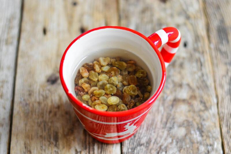 Raisins soaking in a red and white mug