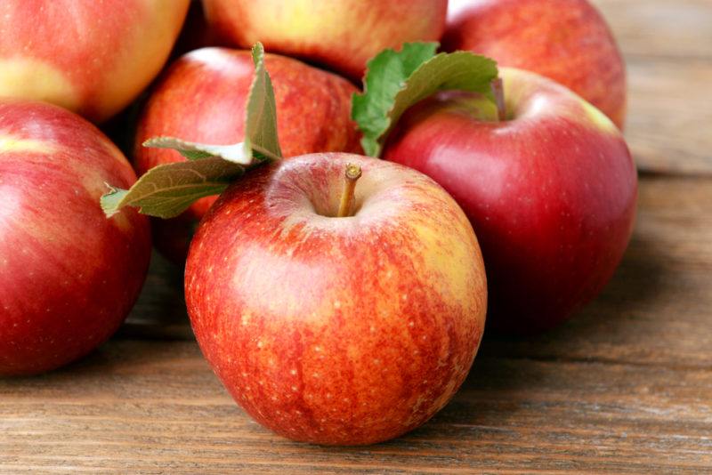 A selection of red apples on a wooden table