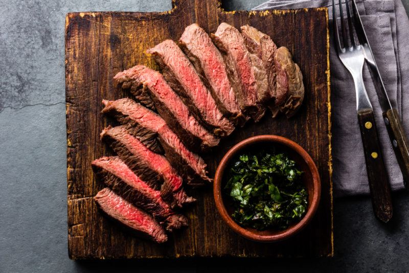 Sliced red meat on a wooden board