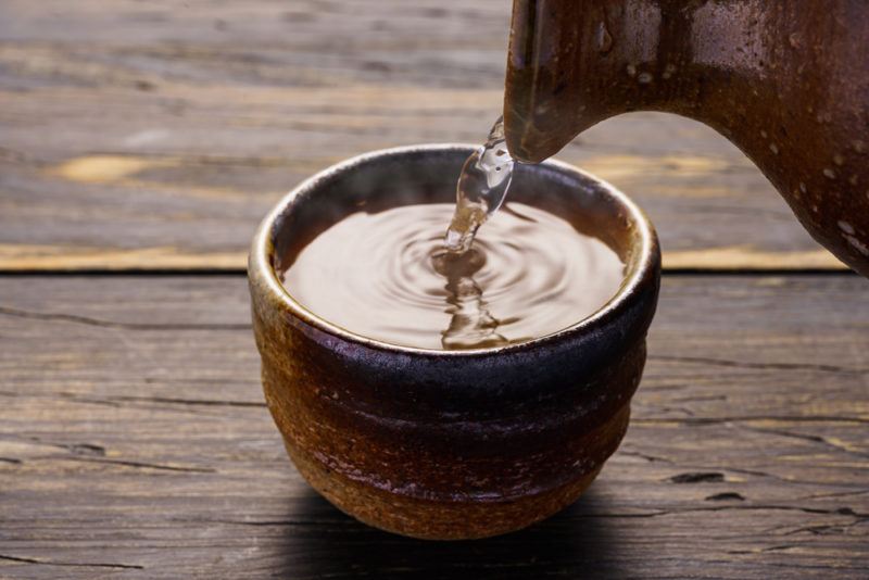 Rice wine being poured into a pottery bowl