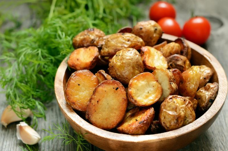 A bowl containing roasted potatoes