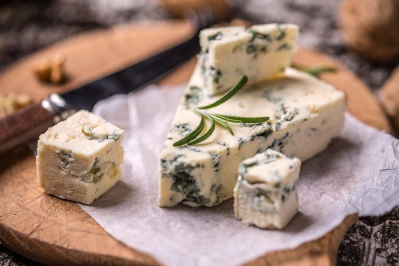 Roquefort cheese with walnuts on a wooden board