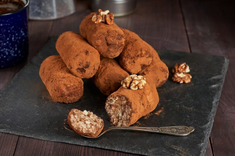 A selection of Russian truffles called kartoshka. They are vaguely in the shape of potatos. One has been cut open so the interior can be seen