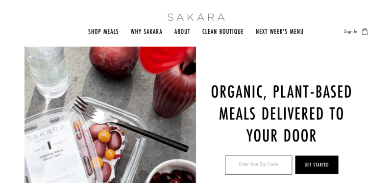 Sakara website screenshot showing a fruit salad with a bottle of water and an apple