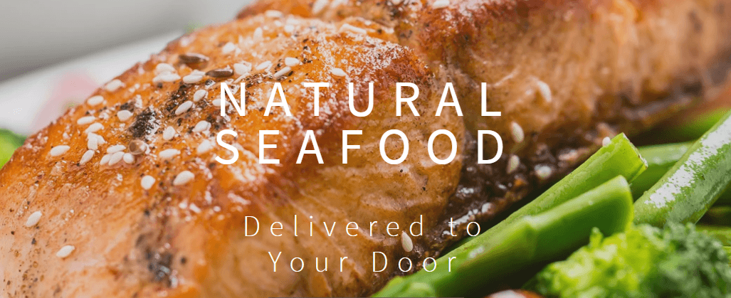 Grilled salmon filet garnished with sesame seeds with a side of broccolini. 
In white font in says Natural Seafood Delivered to your door