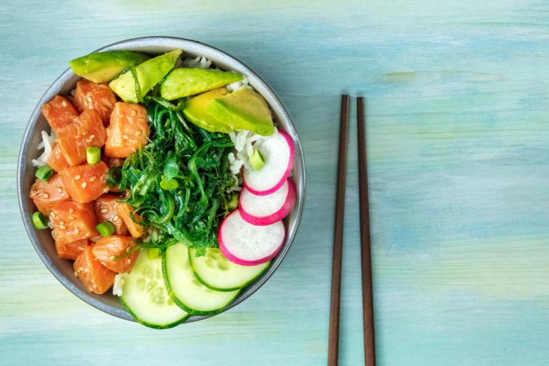 A poke bowl with salmon, radish, and avocado