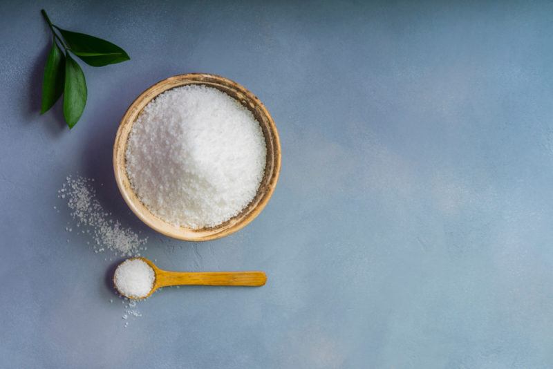 A bowl of salt with a spoon